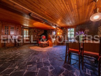 Rustic mountain home with stone fireplace and wood-beamed ceilings.