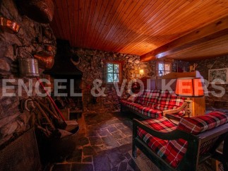 Rustic mountain retreat with stone walls and wood-beamed ceilings.