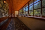 This charming property boasts a sun-drenched hallway with rustic stone walls and wooden flooring.