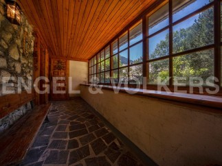 This charming property boasts a sun-drenched hallway with rustic stone walls and wooden flooring.