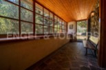 This charming property boasts a sun-drenched veranda with expansive windows offering breathtaking views of the surrounding landscape.