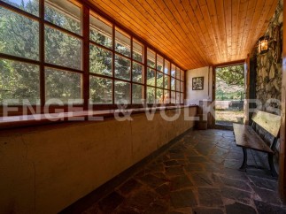This charming property boasts a sun-drenched veranda with expansive windows offering breathtaking views of the surrounding landscape.