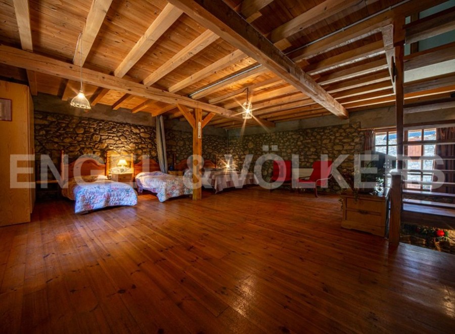 Rustic charm meets modern comfort in this unique property boasting exposed wooden beams and stone walls.