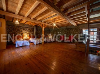 Rustic charm meets modern comfort in this unique property boasting exposed wooden beams and stone walls.