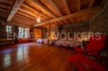 Rustic charm meets modern comfort in this unique wooden-beamed house.