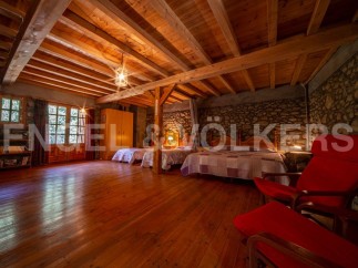 Rustic charm meets modern comfort in this unique wooden-beamed house.