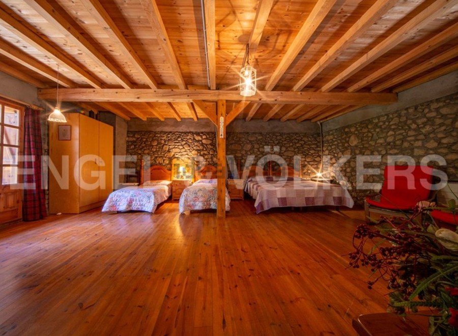 Rustic charm meets modern comfort in this unique property boasting a stunning wooden beamed ceiling and stone walls.