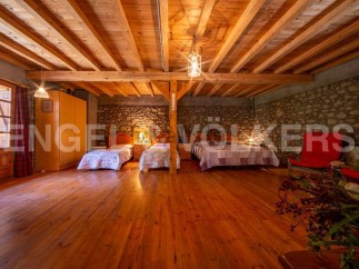 Rustic charm meets modern comfort in this unique property boasting a stunning wooden beamed ceiling and stone walls.