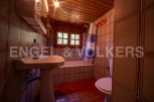 Cozy bathroom with wooden accents and tiled walls.
