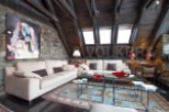This stunning property boasts a spacious living area with exposed wooden beams and stone walls, creating a rustic yet elegant atmosphere.