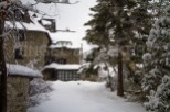 This charming stone house is nestled in a snowy winter wonderland, offering a cozy retreat.