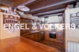 Rustic kitchen with wooden beams, exposed brick, and antique copper cookware.