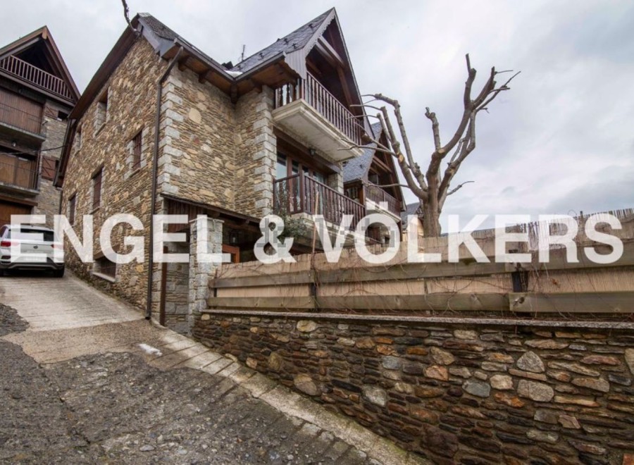 This charming stone house boasts a unique blend of rustic and modern design.