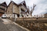 This charming stone house boasts a unique blend of rustic and modern design.