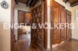 This stunning property boasts exquisite wooden features throughout, including intricately carved doors and built-in wardrobes.