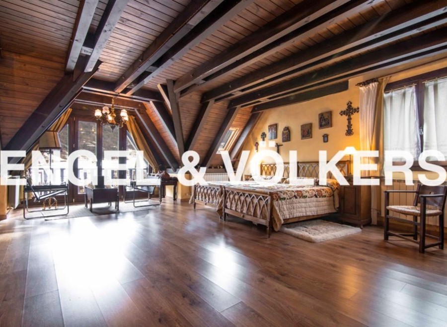 This stunning property boasts a spacious master bedroom with high wooden beamed ceilings and large windows offering abundant natural light.