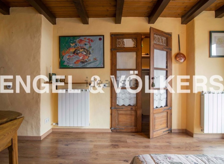 Charming rustic bedroom with wooden beamed ceiling and antique wardrobe.