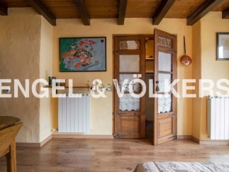 Charming rustic bedroom with wooden beamed ceiling and antique wardrobe.