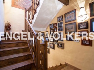This charming property features a beautiful wooden staircase, adding a touch of elegance to the home.