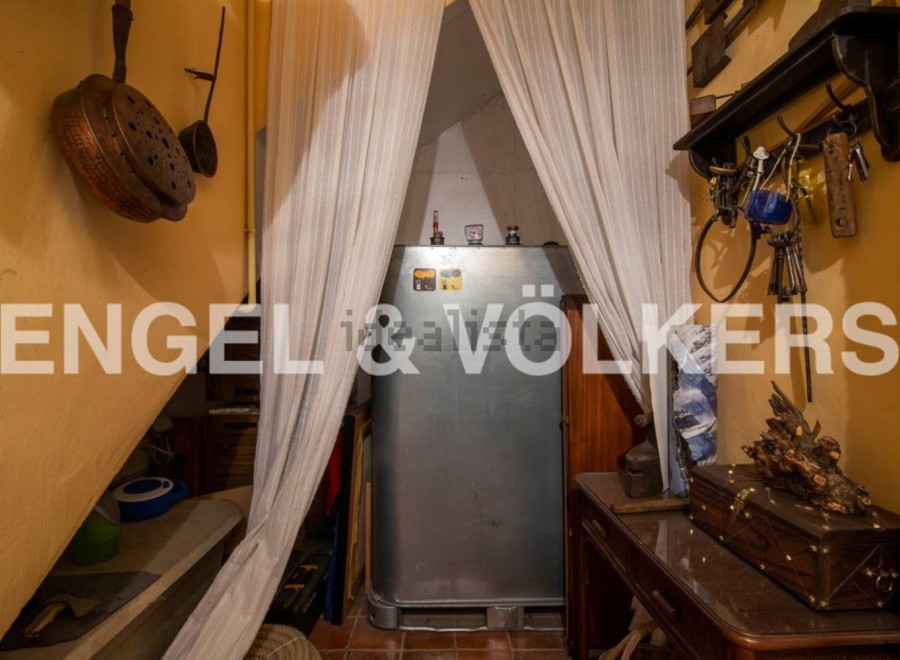 Discover this unique property featuring a charming storage area under the stairs, complete with antique cookware and tools.