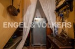 Discover this unique property featuring a charming storage area under the stairs, complete with antique cookware and tools.