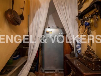 Discover this unique property featuring a charming storage area under the stairs, complete with antique cookware and tools.