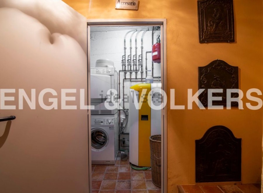 This stunning property boasts a dedicated laundry room complete with modern appliances, conveniently located just off the main hallway.