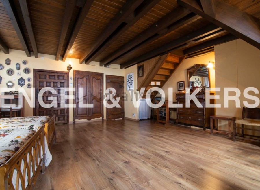 This stunning property boasts a spacious bedroom with antique wooden furniture and a beautiful wooden floor.