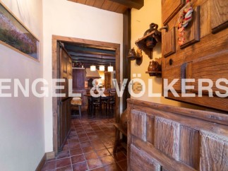 This charming property boasts a rustic interior with exposed wooden beams and antique furniture.