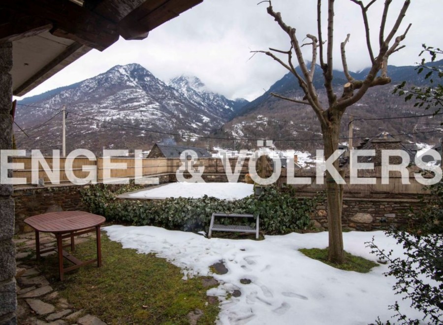 Mountain views and a snow-dusted garden greet you at this charming property.