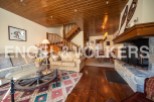 This stunning chalet boasts a spacious living area with hardwood floors, a cozy fireplace, and ample natural light.