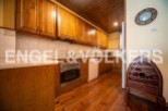 Rustic kitchen with wooden cabinets and flooring.