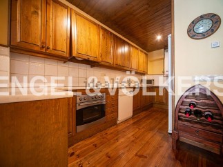 Rustic kitchen with wooden cabinets and flooring.
