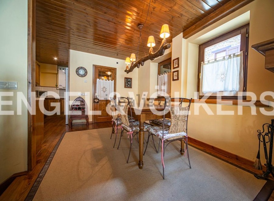Charming dining room with wooden ceiling and rustic decor.