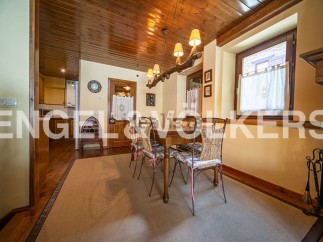 Charming dining room with wooden ceiling and rustic decor.