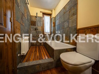 Charming bathroom with wooden features and slate tile.