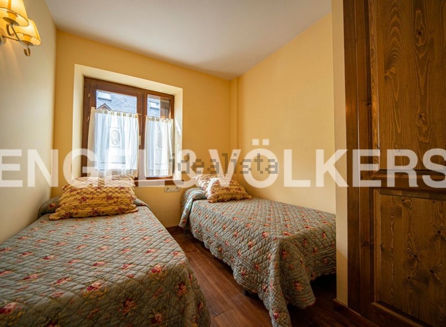Charming bedroom with twin beds and floral bedding, offering a cozy and comfortable atmosphere.