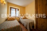 Charming bedroom with twin beds and floral bedding, offering a cozy and comfortable atmosphere.