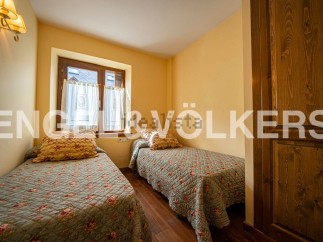Charming bedroom with twin beds and floral bedding, offering a cozy and comfortable atmosphere.