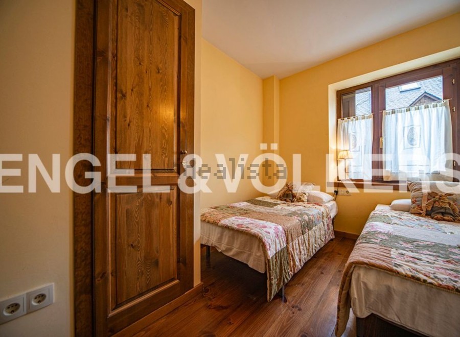 Charming bedroom with two twin beds, perfect for guests or children.