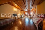 This charming attic room boasts a rustic wooden interior with exposed beams and hardwood floors.