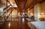 This stunning property boasts a spacious loft with exposed wooden beams and hardwood floors, creating a warm and inviting atmosphere.