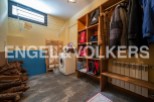 This charming property boasts a dedicated laundry room, complete with a washing machine and ample storage solutions.