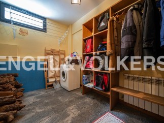 This charming property boasts a dedicated laundry room, complete with a washing machine and ample storage solutions.