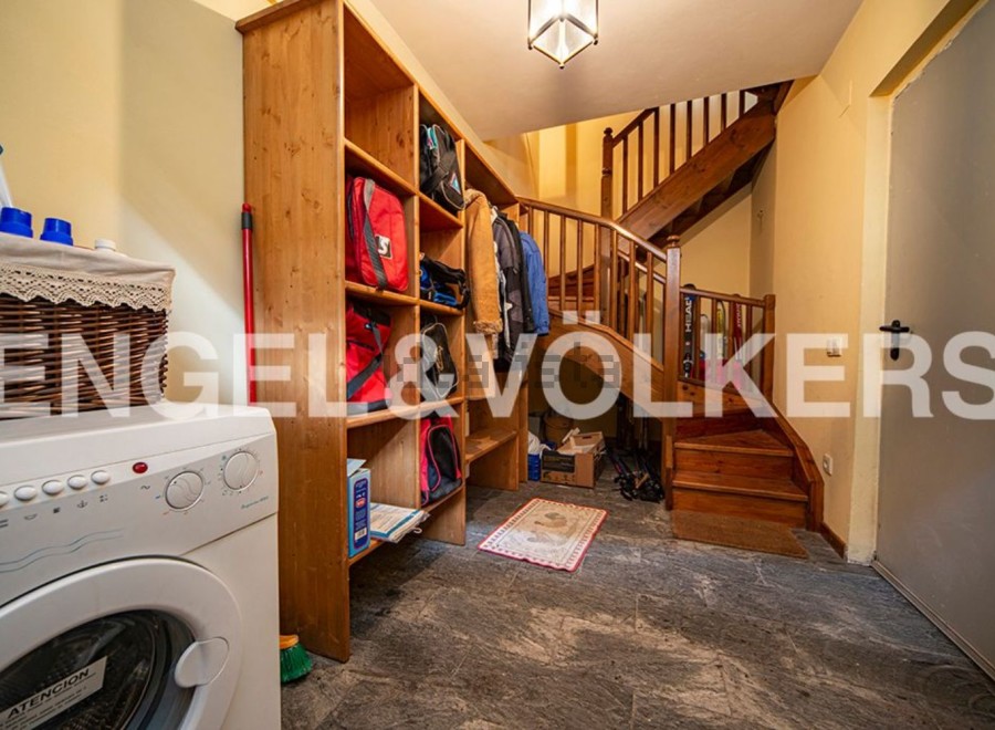 This charming property boasts a convenient laundry area with a washer and ample storage solutions.