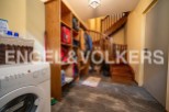 This charming property boasts a convenient laundry area with a washer and ample storage solutions.