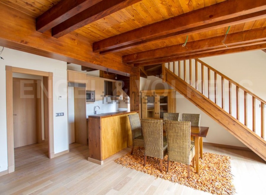 This stunning property boasts a spacious open-plan living area with a modern kitchen and dining area.