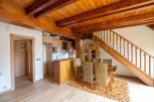 This stunning property boasts a spacious open-plan living area with a modern kitchen and dining area.