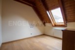 Charming attic room with wooden beams and skylight.