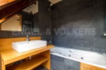 This stunning bathroom boasts a luxurious jacuzzi tub and modern sink, perfect for relaxation.